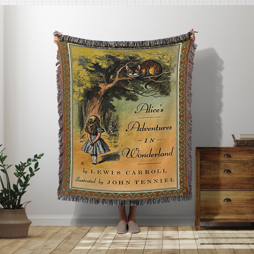 Alice in Wonderland woven throw blanket showing the vintage book cover with the Cheshire Cat
