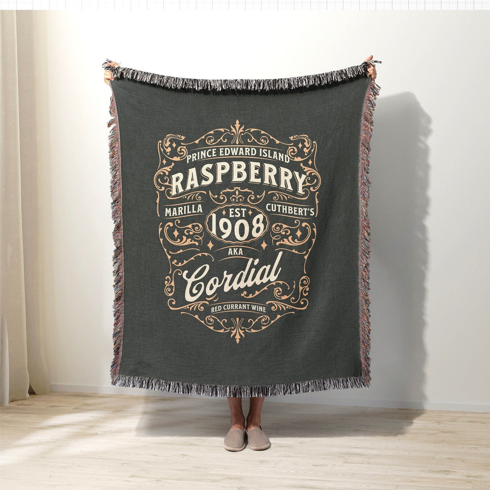 Anne of Green Gables woven throw blanket with a vintage raspberry cordial label design