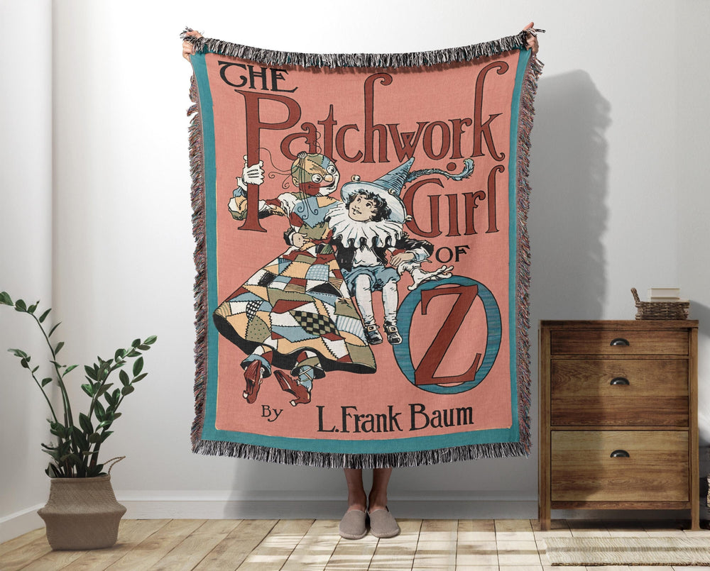 The Patchwork Girl of Oz woven throw blanket showing the vintage cover with Scraps and Ojo