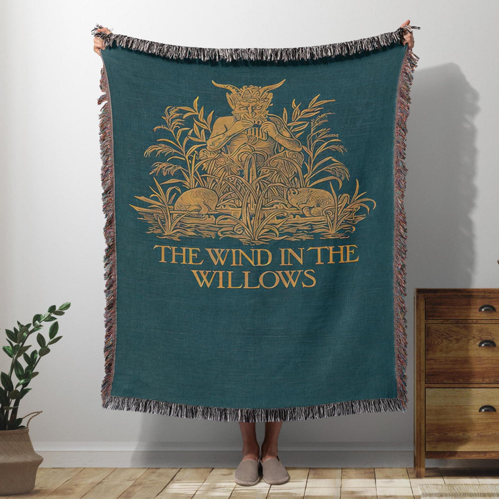 The Wind in the Willows woven throw blanket showing the gold piper among the reeds on deep teal