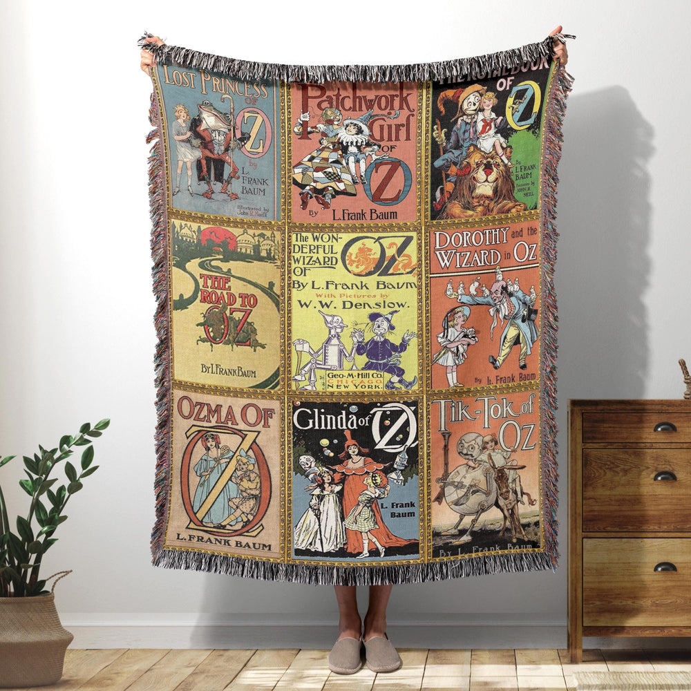 Wizard of Oz woven throw blanket showing nine vintage Oz series book covers