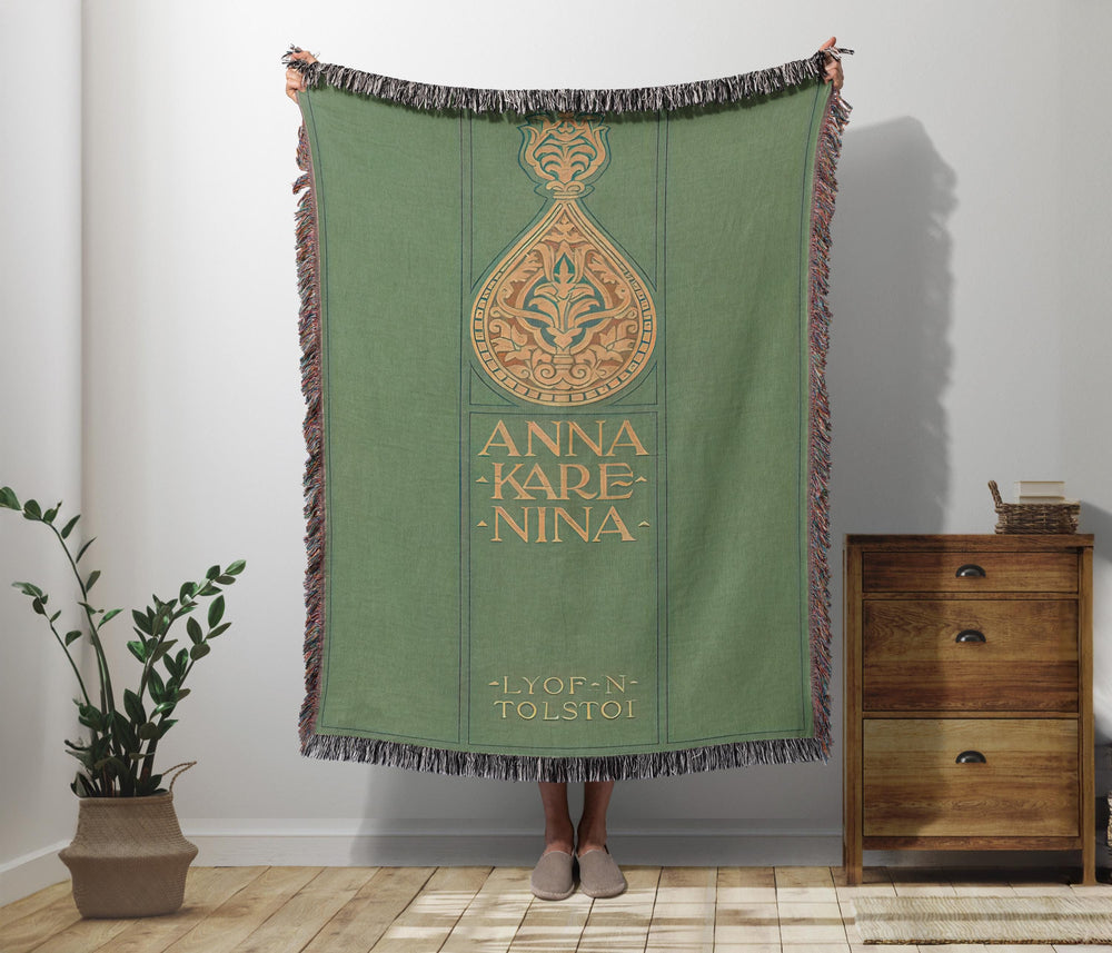 Anna Karenina woven throw blanket showing the vintage green cover with ornate gold ornament and Lyof N. Tolstoi lettering