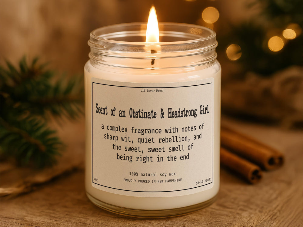 Obstinate Headstrong Girl soy candle in an amber jar with Jane Austen themed label