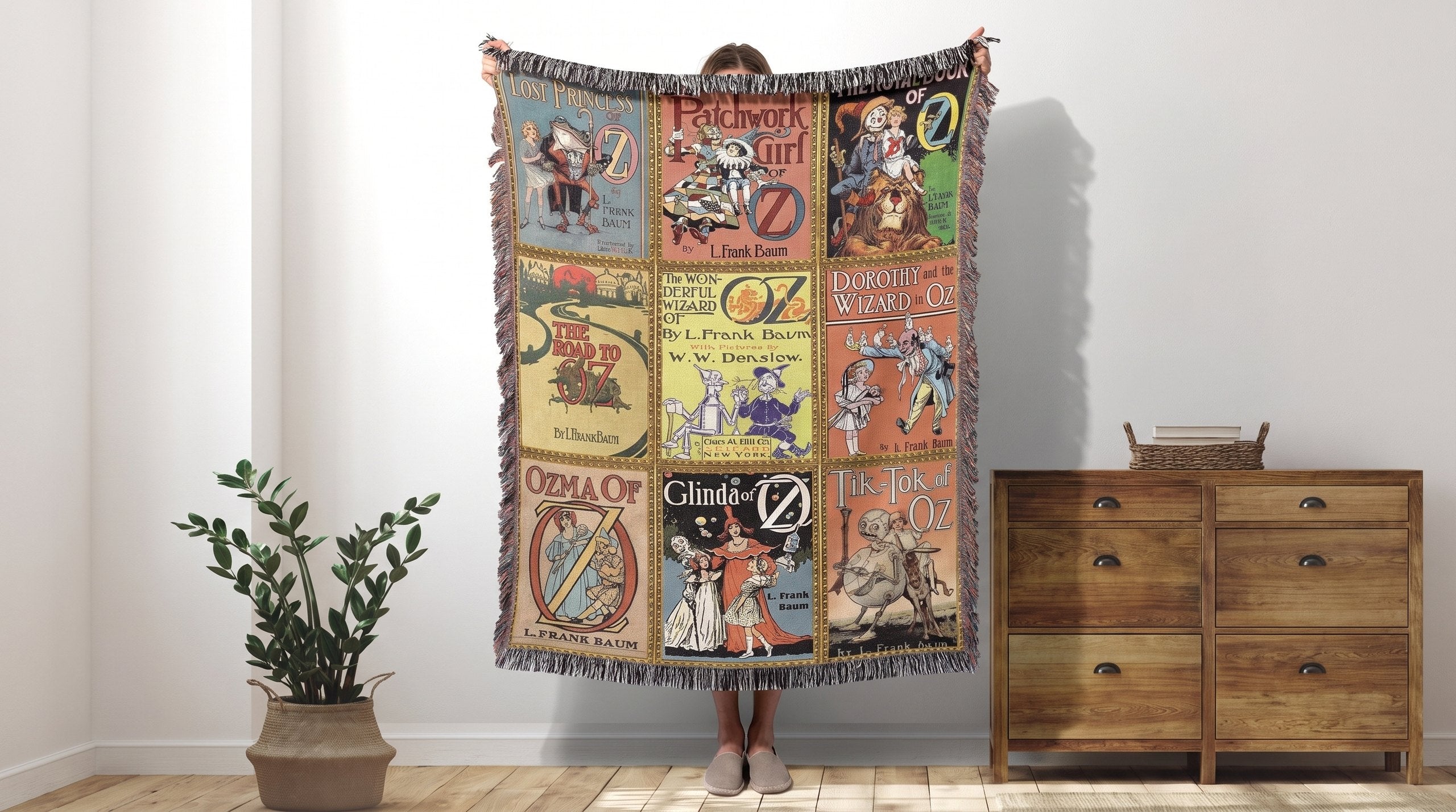 Wizard of Oz vintage book cover woven throw blanket held up in a bright room