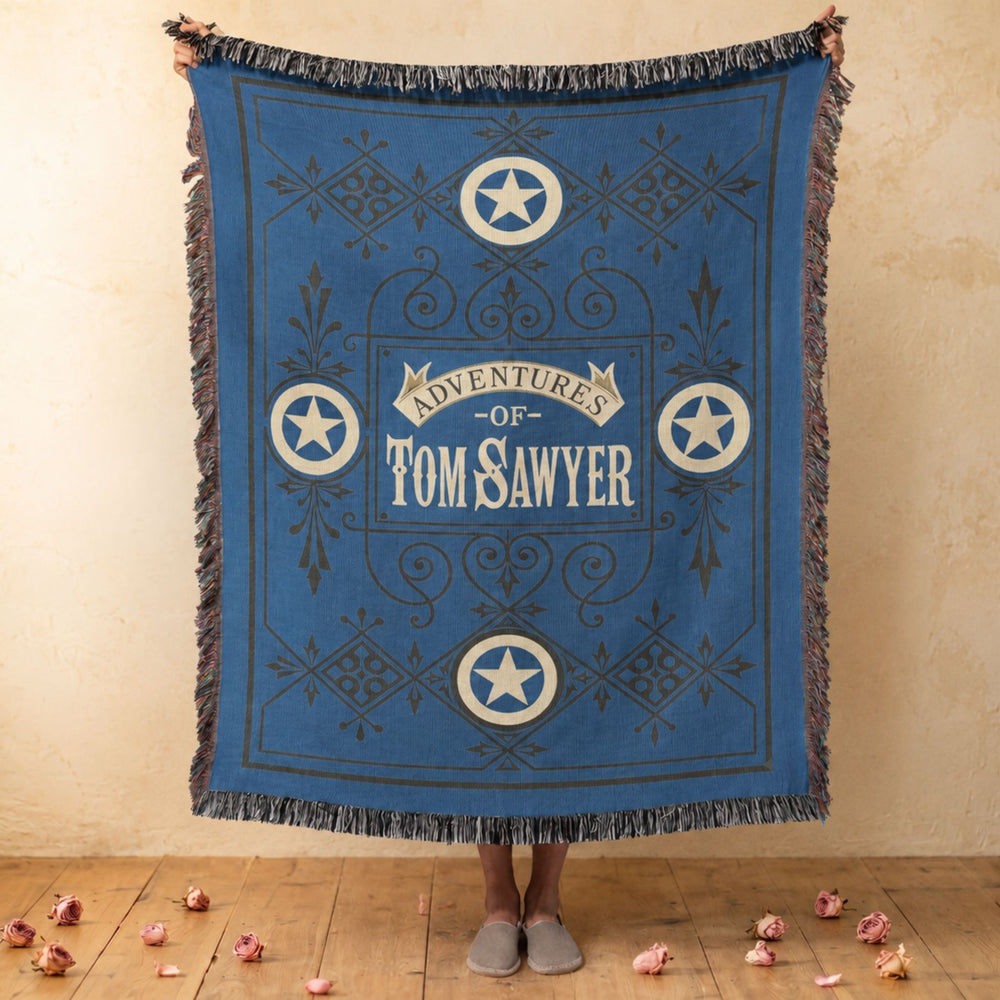 Tom Sawyer woven throw blanket showing the vintage blue cover with star medallions